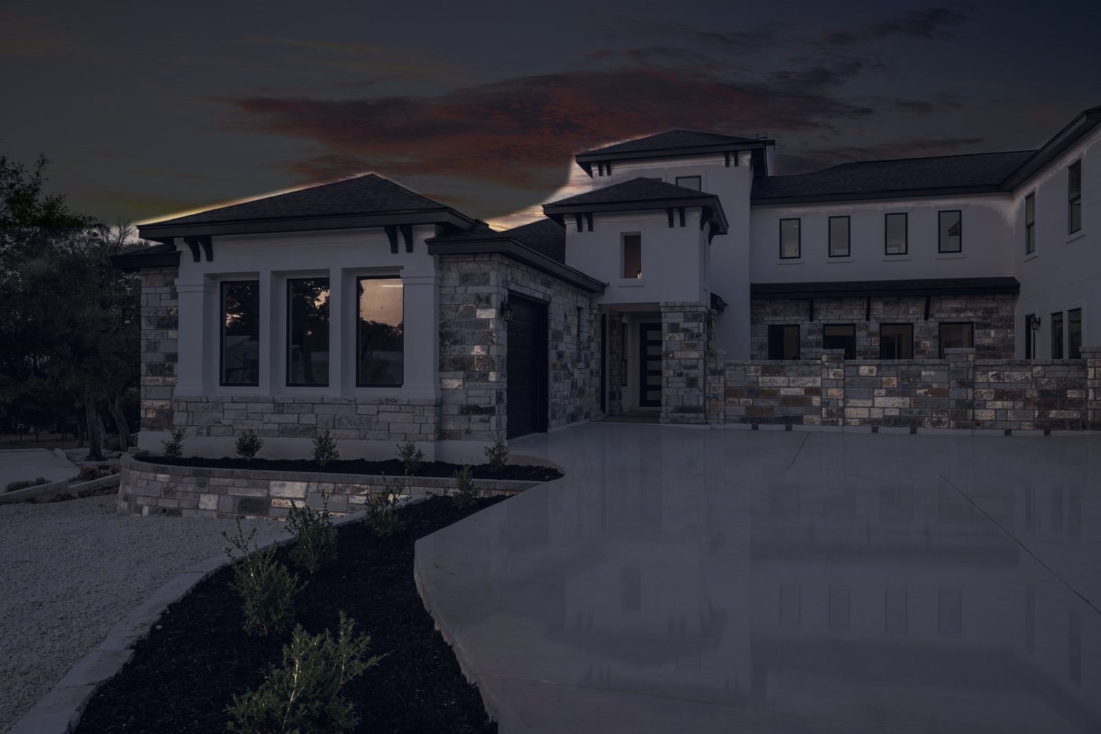 stone and stucco home before lighting